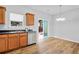 Bright kitchen with stainless dishwasher, wood cabinets and view to backyard at 1797 Brookside Lay Cir, Norcross, GA 30093