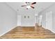 Spacious living room with light-colored walls, wood-look flooring, and a modern ceiling fan at 1797 Brookside Lay Cir, Norcross, GA 30093