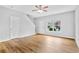 Open-concept living room with light-colored walls, wood-look floors, and access to the staircase at 1797 Brookside Lay Cir, Norcross, GA 30093