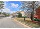 Street view of townhomes showcasing well-maintained landscaping and available parking at 1797 Brookside Lay Cir, Norcross, GA 30093