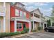 View of a red townhouse with inviting front entrances and parking available at 1797 Brookside Lay Cir, Norcross, GA 30093