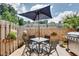 Outdoor patio space with a table, chairs, umbrella, grill, and privacy fence at 2968 Greyhawk Ln, Cumming, GA 30040