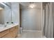 Clean bathroom with a white vanity, large mirror, and shower with curtain at 2968 Greyhawk Ln, Cumming, GA 30040