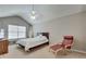 Cozy bedroom featuring a ceiling fan, chair and footstool, and a surfboard decoration at 2968 Greyhawk Ln, Cumming, GA 30040