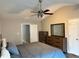Spacious bedroom featuring a ceiling fan, large dresser, and a king sized bed at 2968 Greyhawk Ln, Cumming, GA 30040