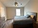Bedroom featuring a ceiling fan, window, wood-look floors, and dresser at 2968 Greyhawk Ln, Cumming, GA 30040