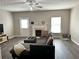 Spacious living room with a fireplace, natural light, and gray wood flooring at 2968 Greyhawk Ln, Cumming, GA 30040