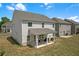 View of a back yard of a house with a small covered patio and green grass at 70 Clark Lake Ln, Grayson, GA 30017