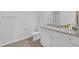 Bathroom featuring granite countertops, white cabinets and a modern toilet at 70 Clark Lake Ln, Grayson, GA 30017