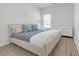 Cozy bedroom with a modern bed, hardwood floors, and a bright window at 70 Clark Lake Ln, Grayson, GA 30017