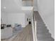 Welcoming foyer featuring a staircase and a view into the living room with modern decor at 70 Clark Lake Ln, Grayson, GA 30017