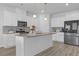 Modern kitchen features white cabinets, granite countertops, stainless steel appliances and large center island at 70 Clark Lake Ln, Grayson, GA 30017