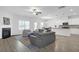 Bright and open living room featuring hardwood floors, a fireplace, and a comfortable seating area at 70 Clark Lake Ln, Grayson, GA 30017