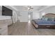 Bright main bedroom featuring wood floors, tray ceilings, natural light, and modern furniture at 70 Clark Lake Ln, Grayson, GA 30017