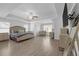 Spacious main bedroom with tray ceiling, wood floors, TV, sitting area, and natural light at 70 Clark Lake Ln, Grayson, GA 30017