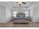 Serene bedroom with a neutral color palette, tray ceiling, and ample natural light from the windows at 70 Clark Lake Ln, Grayson, GA 30017