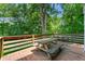 Wooden back deck with a wooden picnic table and green trees in the background at 1326 Mcpherson Ave., Atlanta, GA 30316