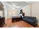 Spacious bedroom with hardwood floors, a large bed, sofa, and dresser for ample storage at 1326 Mcpherson Ave., Atlanta, GA 30316