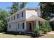 A charming two-story home with a well-manicured lawn, mature trees, and classic black shutters at 1326 Mcpherson Ave., Atlanta, GA 30316