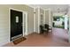 Welcoming front porch with black chairs, a welcome mat, and a painted wood floor at 1326 Mcpherson Ave., Atlanta, GA 30316
