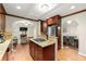 Open-concept kitchen with a kitchen island, hardwood floors, and easy access to the dining and living areas at 1326 Mcpherson Ave., Atlanta, GA 30316