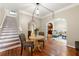 Open-concept living room featuring hardwood floors, arched doorways, and staircase at 1326 Mcpherson Ave., Atlanta, GA 30316