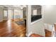 Open living room with hardwood floors, ceiling fan, and adjacent laundry area at 1326 Mcpherson Ave., Atlanta, GA 30316