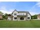 Expansive backyard view showcasing the home’s white exterior, covered patio, and lush lawn at 1375 Harris Rd, Lawrenceville, GA 30043