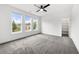 Large bedroom features plush carpet, three windows, and a walk-in closet at 1375 Harris Rd, Lawrenceville, GA 30043