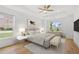 Cozy staged bedroom featuring two windows, hardwood flooring and natural light at 1375 Harris Rd, Lawrenceville, GA 30043