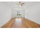 Empty bedroom featuring tray ceiling, ceiling fan, hardwood flooring and natural light at 1375 Harris Rd, Lawrenceville, GA 30043