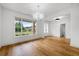 Elegant dining room features hardwood floors, large windows and stylish lighting fixture creating a refined atmosphere at 1375 Harris Rd, Lawrenceville, GA 30043