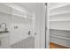 Clean laundry room with black and white patterned floors, ample shelving, and storage space at 1375 Harris Rd, Lawrenceville, GA 30043