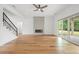 Open concept living room features sleek fireplace, hardwood flooring, and sliding glass doors to the patio at 1375 Harris Rd, Lawrenceville, GA 30043