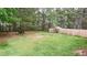 Large backyard with mature trees and a wood fence at 1941 Patterson Park Dr, Lawrenceville, GA 30044