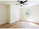 Well-lit bedroom with ceiling fan, neutral paint, and wood-look flooring at 1941 Patterson Park Dr, Lawrenceville, GA 30044
