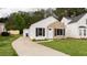 Inviting home exterior with a curved driveway, manicured lawn, and attractive brick and siding details at 1941 Patterson Park Dr, Lawrenceville, GA 30044