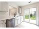 Modern kitchen featuring sleek countertops, stainless steel appliances, and a sliding glass door for easy access to outdoors at 1941 Patterson Park Dr, Lawrenceville, GA 30044