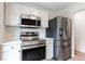 Modern kitchen with stainless steel appliances, sleek countertops and ample cabinet space for storage at 1941 Patterson Park Dr, Lawrenceville, GA 30044