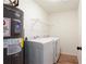 Laundry room with modern washer and dryer, water heater and wire shelving at 1941 Patterson Park Dr, Lawrenceville, GA 30044