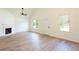 Inviting living room featuring a fireplace, hardwood floors, and ample natural light from large windows at 1941 Patterson Park Dr, Lawrenceville, GA 30044