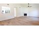 Bright living room with a fireplace, modern flooring, and an open view to the kitchen at 1941 Patterson Park Dr, Lawrenceville, GA 30044