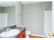 Bathroom featuring cherry cabinetry, a white sink, and a tub with a shower at 2384 Coach Way, Jonesboro, GA 30236
