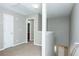 Hallway featuring gray walls and carpeted floors, with access to the upper and lower floors at 2384 Coach Way, Jonesboro, GA 30236