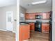 Modern kitchen showcases wood cabinets, black appliances, and an adjacent outdoor access at 2384 Coach Way, Jonesboro, GA 30236
