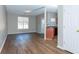 Well-lit living room features wood floors, a large window and a view of the kitchen at 2384 Coach Way, Jonesboro, GA 30236