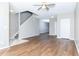 Open living space features wood flooring, neutral paint, and staircase leading to the second level at 2384 Coach Way, Jonesboro, GA 30236