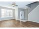 Bright living room with wood floors, a ceiling fan, large windows, and an adjacent entryway at 2384 Coach Way, Jonesboro, GA 30236