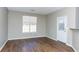 Bright living room featuring wood floors, a large window, and access to the outdoor patio at 2384 Coach Way, Jonesboro, GA 30236