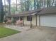 View of the front exterior with an attached garage and mature trees in the background at 4148 Silver Hill Ct, Snellville, GA 30039
